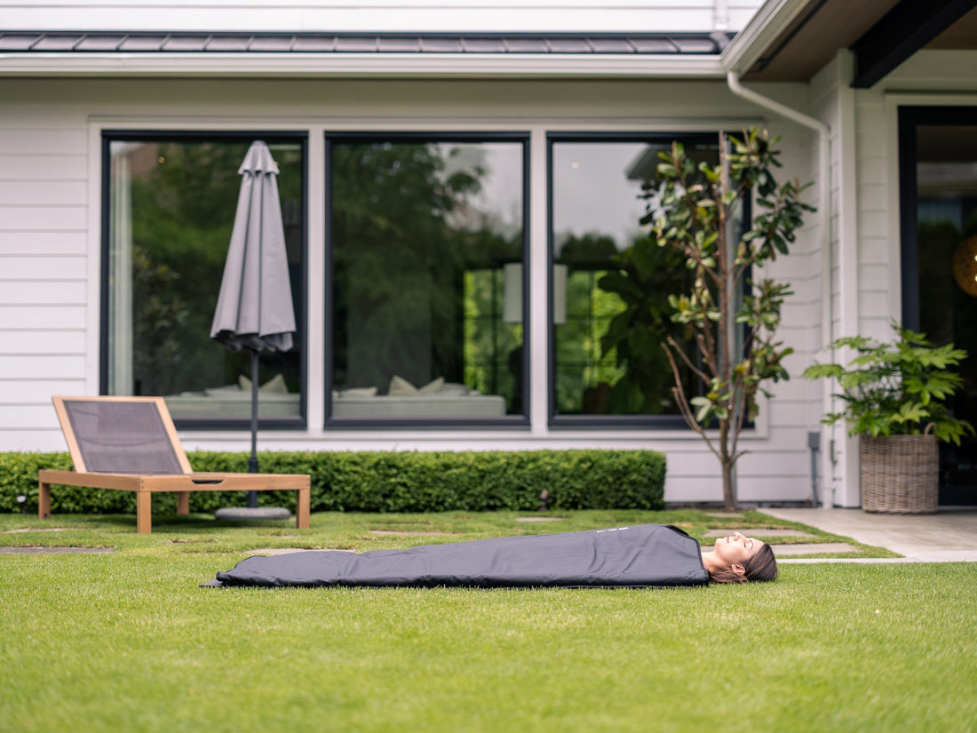 Person relaxing in an Orion Embers infrared sauna blanket