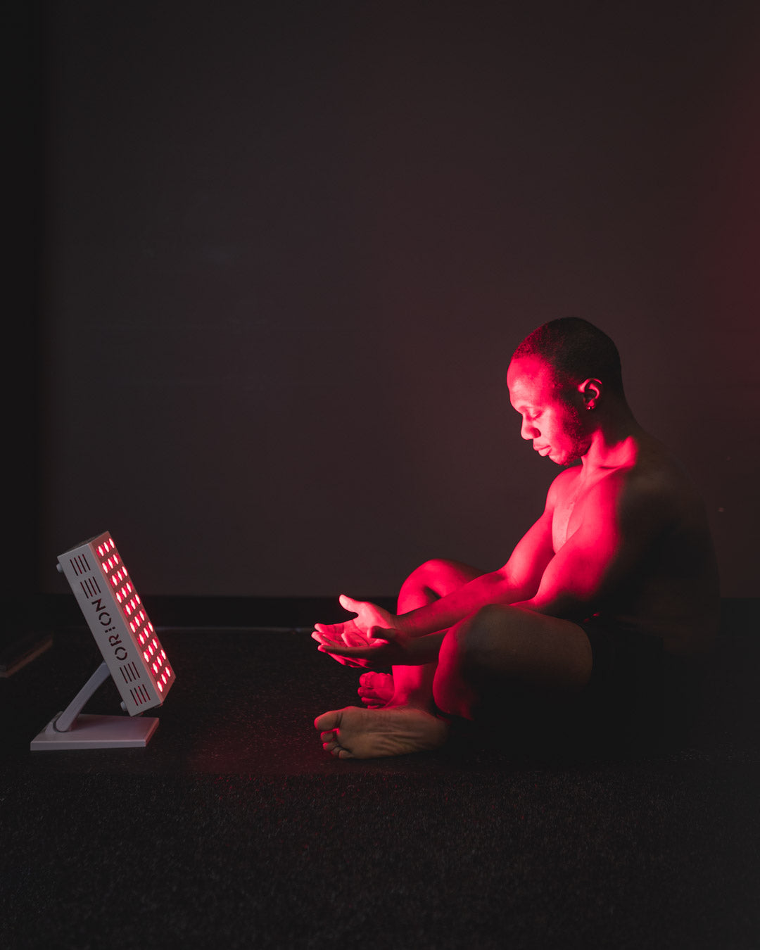 Orion Red Light Therapy - man sitting in front of the Orion Pro 300